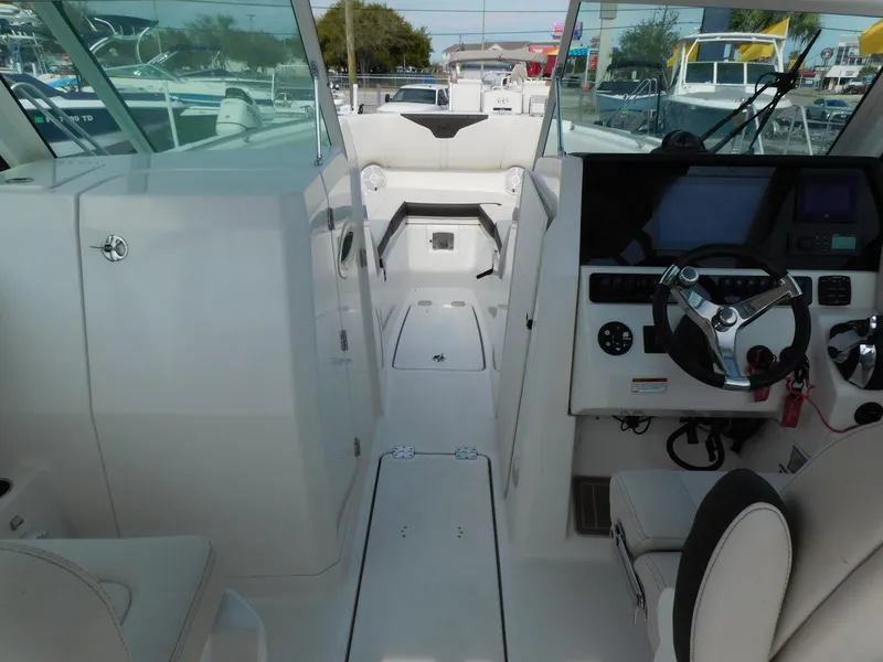 Slide: The Image of 2024 Sailfish 276 DC boat interior with helm, seating, and dashboard. - 18