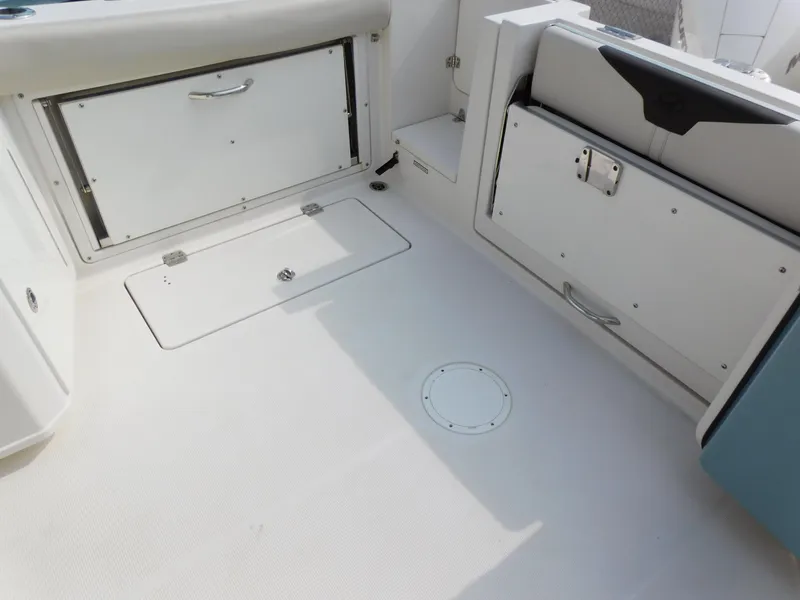 Slide: The Image of 2024 Sailfish 276 DC boat deck with storage compartments. - 19