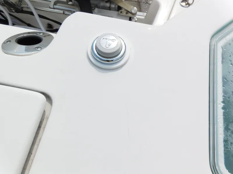 Slide: The Image of Close-up of the 2024 Sailfish 276 DC boat's deck with a power button. - 21