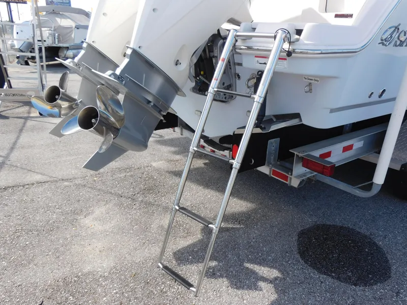 Slide: The Image of 2024 Sailfish 276 DC boat with ladder and dual outboard motors. - 3