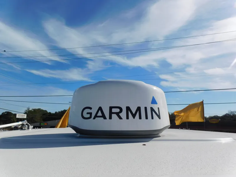 Slide: The Image of Garmin radar on 2024 Sailfish 276 DC boat under a clear blue sky. - 4