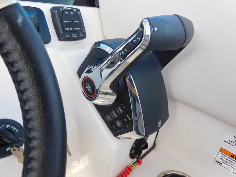 Slide: The Image of Throttle control of 2024 Sailfish 276 DC boat with steering wheel and control panel. - 8