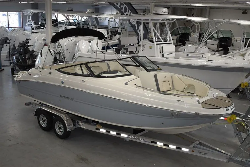 The Image of 2024 Stingray 231DC boat on trailer in showroom. - 0