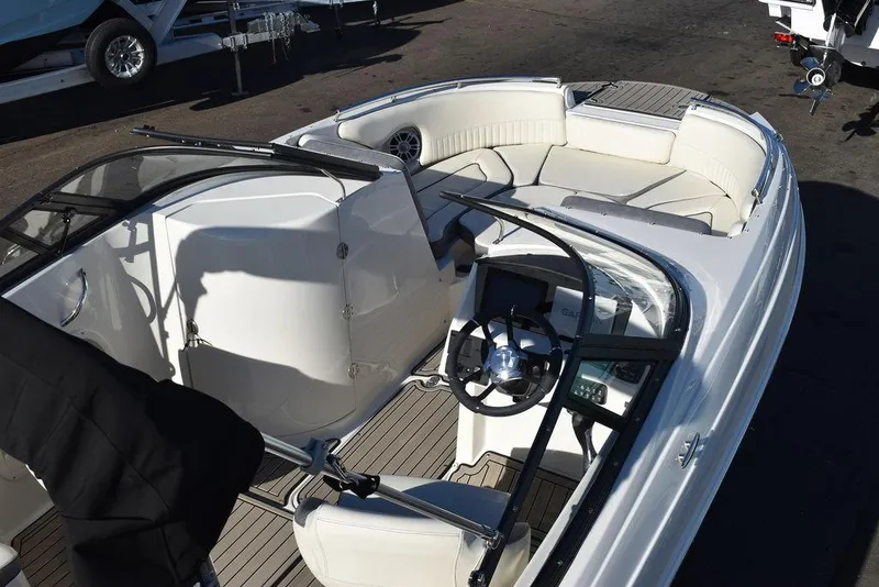 Slide: The Image of 2024 Stingray 231DC boat interior with steering wheel and seating area. - 11