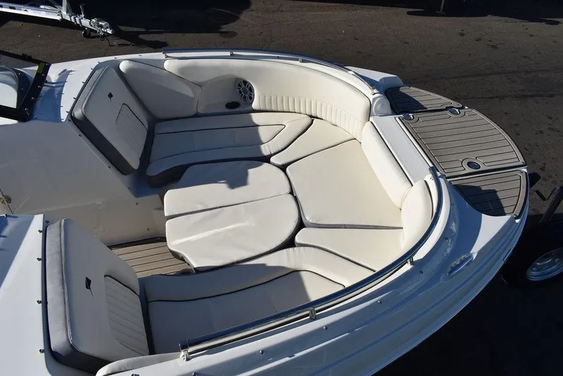 Slide: The Image of 2024 Stingray 231DC boat with spacious, cushioned seating area. - 12