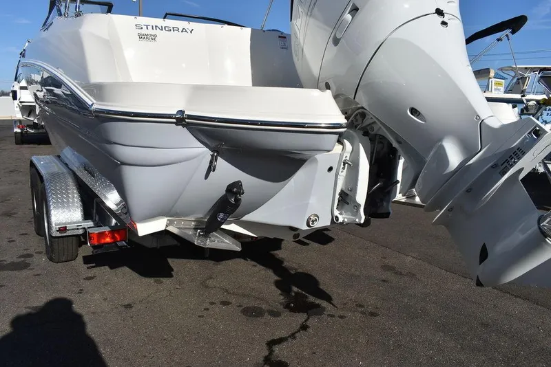 Slide: The Image of 2024 Stingray 231DC boat on trailer, rear view with outboard motor. - 16