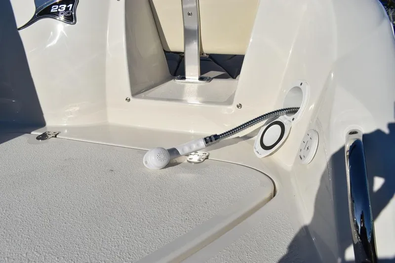 Slide: The Image of 2024 Stingray 231DC boat deck with built-in shower and storage compartment. - 23