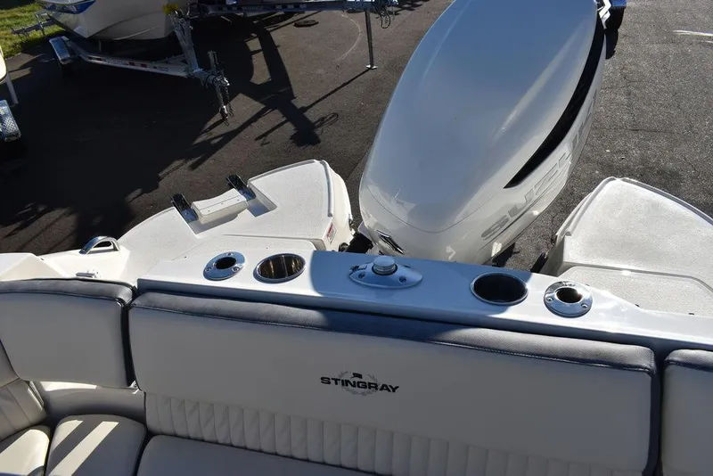 Slide: The Image of 2024 Stingray 231DC boat interior with motor and seating area. - 25