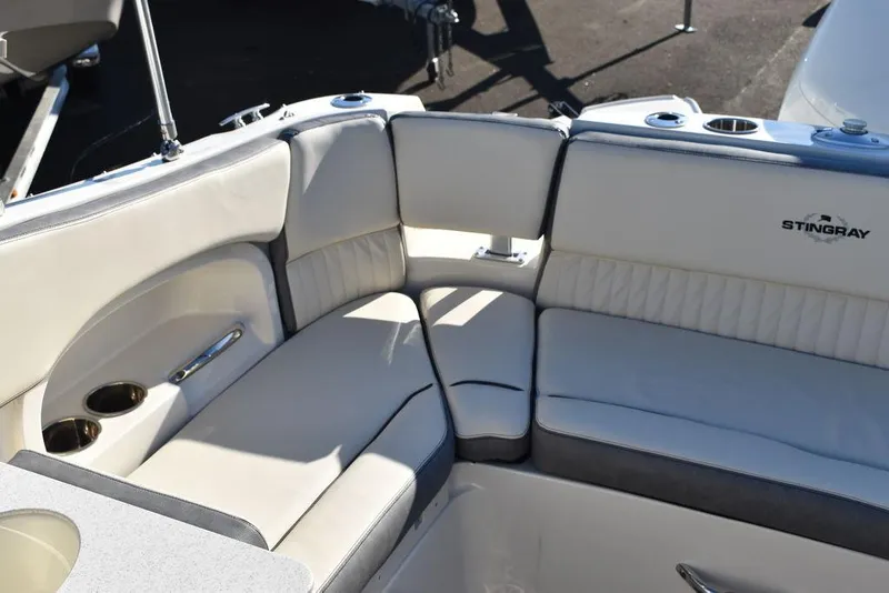 Slide: The Image of 2024 Stingray 231DC boat with luxurious white seating and cup holders. - 26