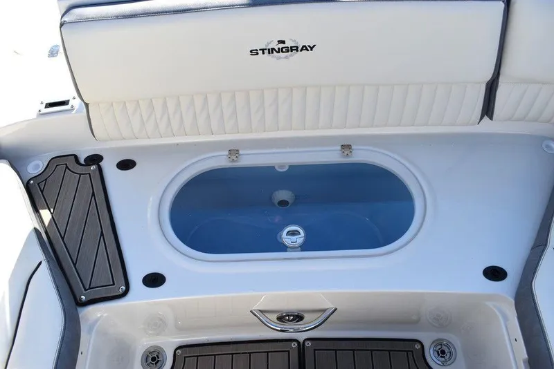 Slide: The Image of 2024 Stingray 231DC boat interior with livewell and storage compartments. - 29