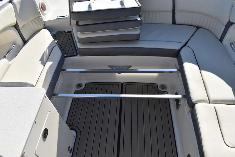 Slide: The Image of 2024 Stingray 231DC boat interior with cushioned seating and storage compartments. - 33