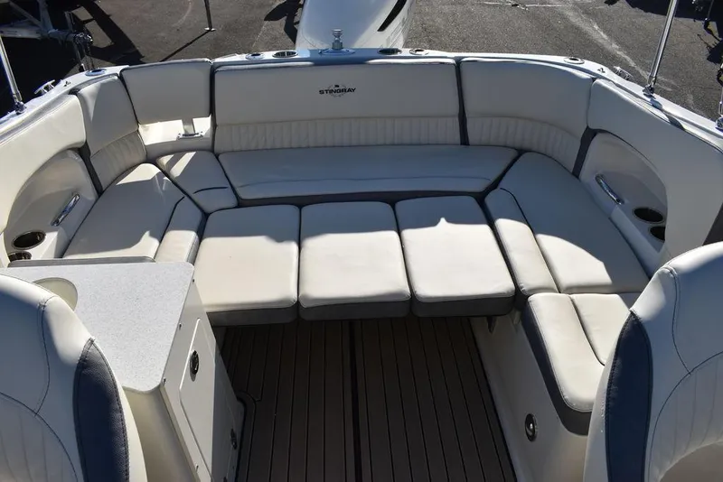 Slide: The Image of 2024 Stingray 231DC boat with spacious seating area and cushioned seats. - 34