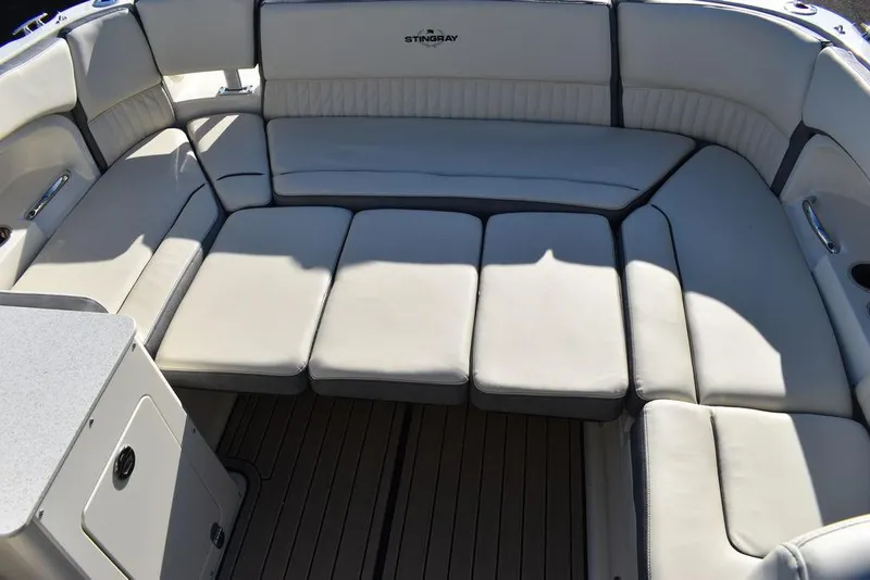 Slide: The Image of 2024 Stingray 231DC boat with spacious cushioned seating area. - 35