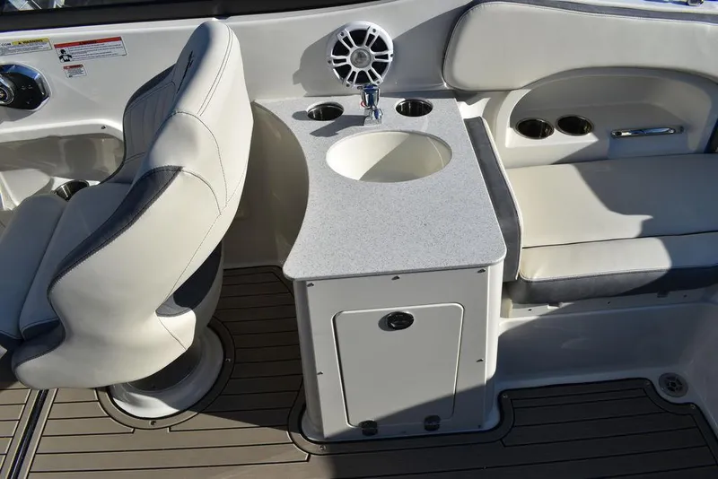 Slide: The Image of 2024 Stingray 231DC boat interior with seating, sink, and storage. - 37