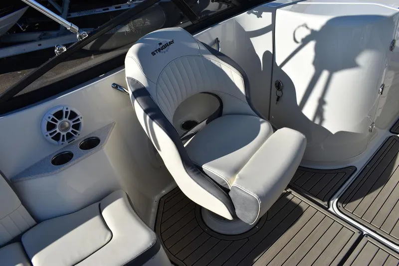 Slide: The Image of 2024 Stingray 231DC boat interior with captain's chair and cup holders. - 40