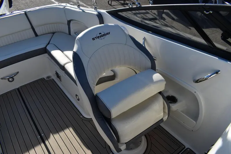 Slide: The Image of 2024 Stingray 231DC boat interior with cushioned seating and steering chair. - 41