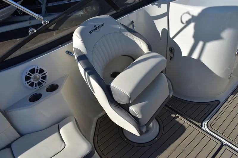 Slide: The Image of 2024 Stingray 231DC boat interior with captain's chair and cup holders. - 42