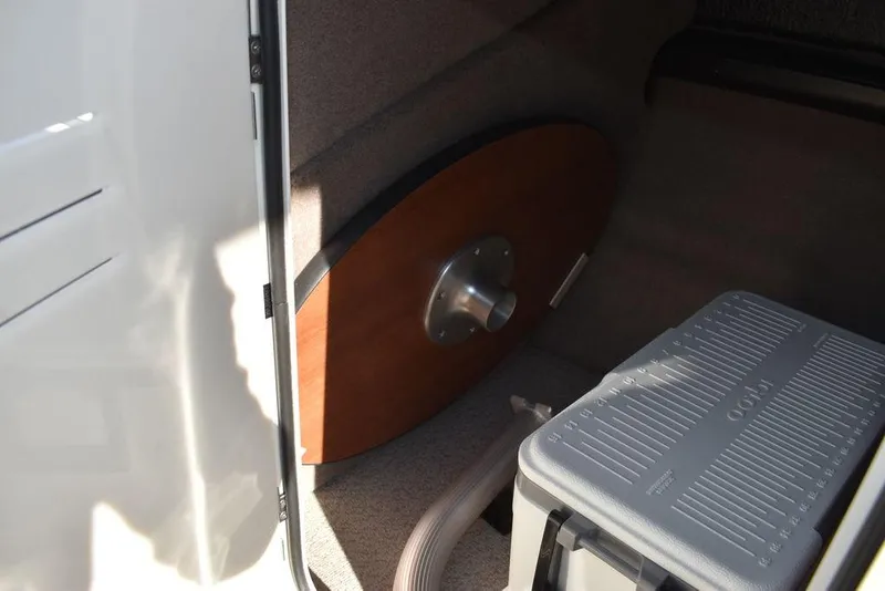 Slide: The Image of 2024 Stingray 231DC storage compartment with table and cooler. - 45