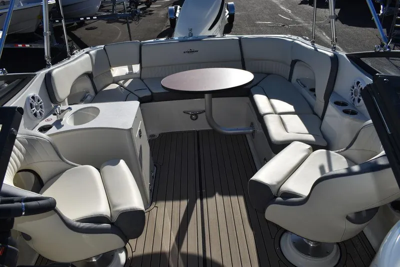 Slide: The Image of 2024 Stingray 231DC boat interior with spacious seating and round table. - 47