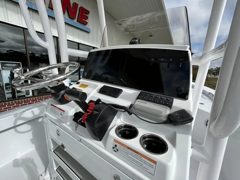 Slide: The Image of 2024 Sportsman Masters 227 Bay Boat console with steering wheel and controls. - 11