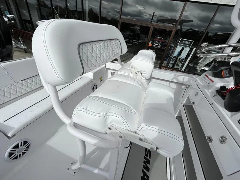 Slide: The Image of 2024 Sportsman Masters 227 Bay Boat with white cushioned seating and modern design. - 12