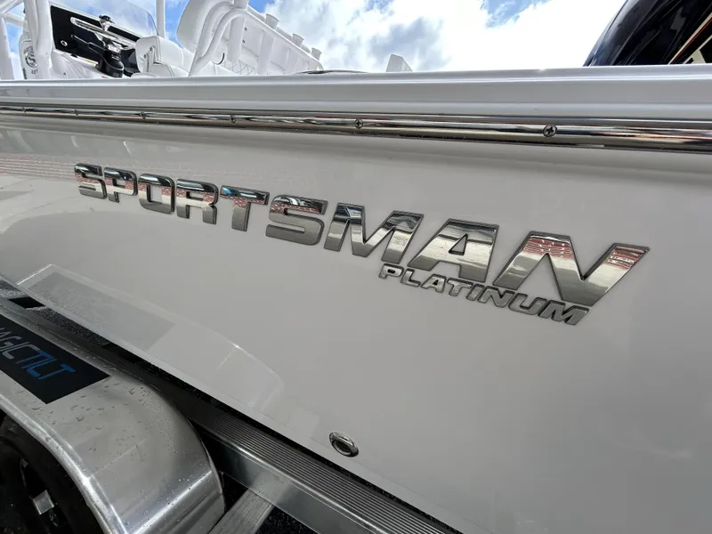 Slide: The Image of 2024 Sportsman Masters 227 Bay Boat side view with logo. - 14
