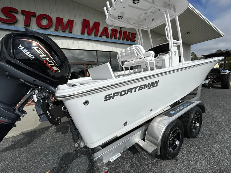 Slide: The Image of 2024 Sportsman Masters 227 Bay Boat on trailer outside marine dealership. - 2
