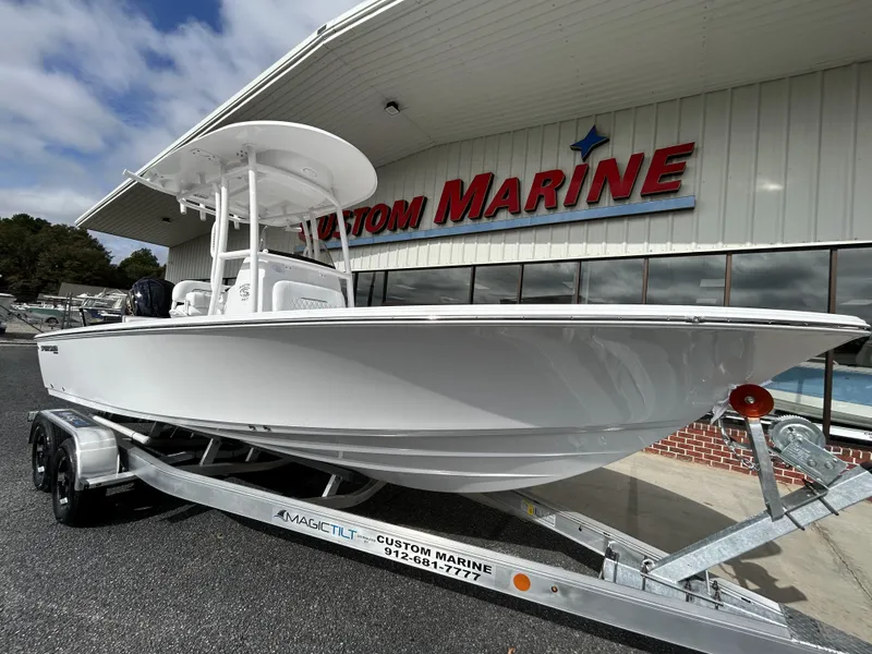 Slide: The Image of 2024 Sportsman Masters 227 Bay Boat on trailer at Custom Marine dealership. - 4