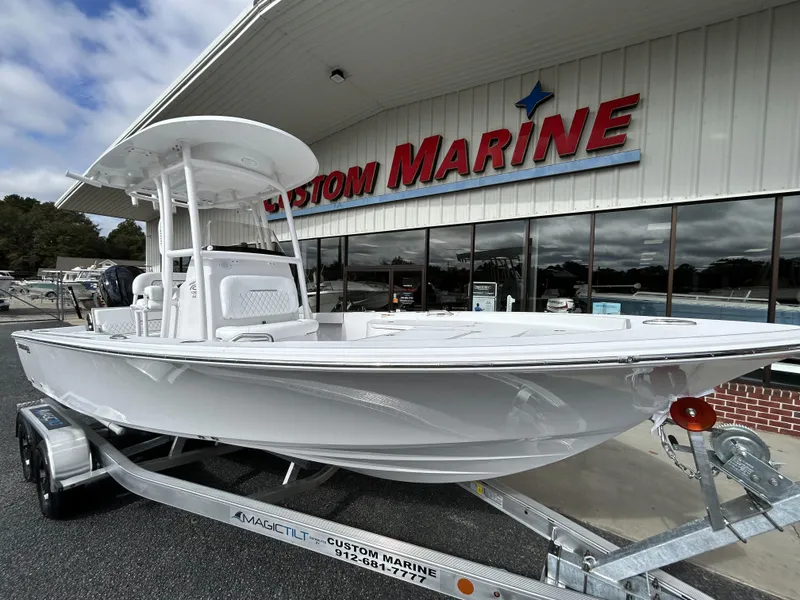 Slide: The Image of 2024 Sportsman Masters 227 Bay Boat on trailer outside Custom Marine dealership. - 5