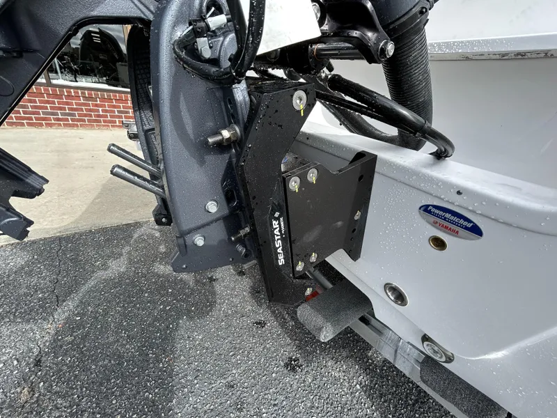 Slide: The Image of 2024 Sportsman Masters 227 Bay Boat rear view showing SeaStar hydraulic steering system. - 8