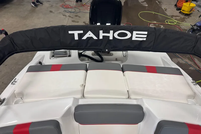 Slide: The Image of 2024 Tahoe T16 boat interior with cushioned seating and protective cover. - 15
