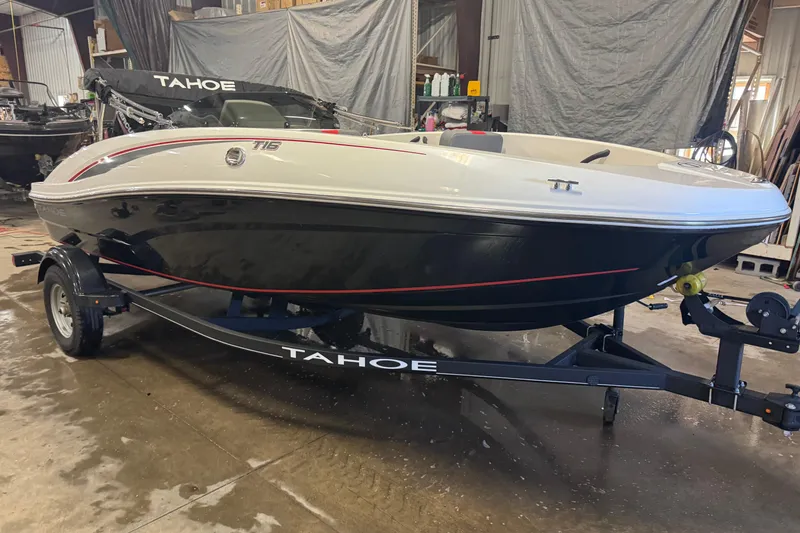 Slide: The Image of 2024 Tahoe T16 boat on trailer in indoor storage facility. - 2