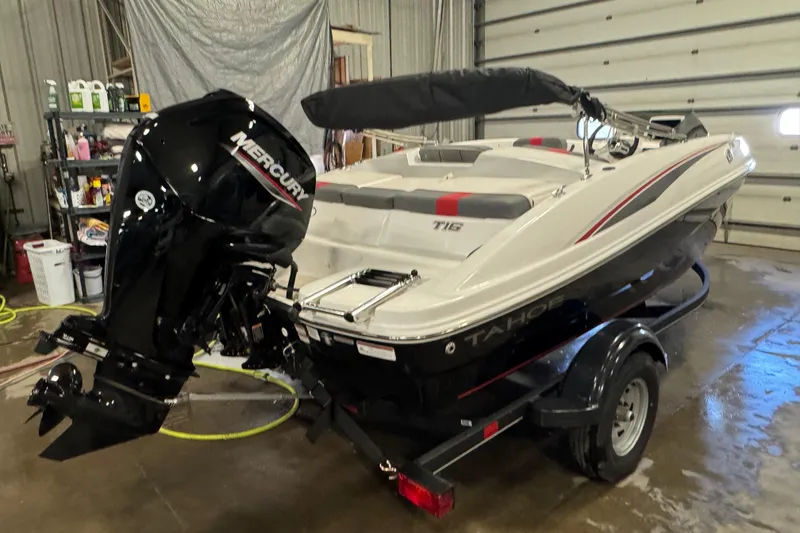 Slide: The Image of 2024 Tahoe T16 boat with Mercury engine in a garage setting. - 3