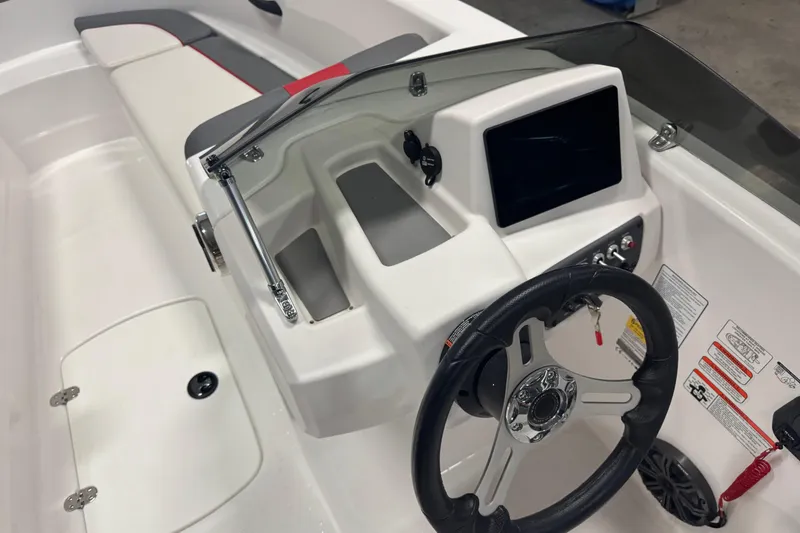 Slide: The Image of 2024 Tahoe T16 boat dashboard with steering wheel and control panel. - 5