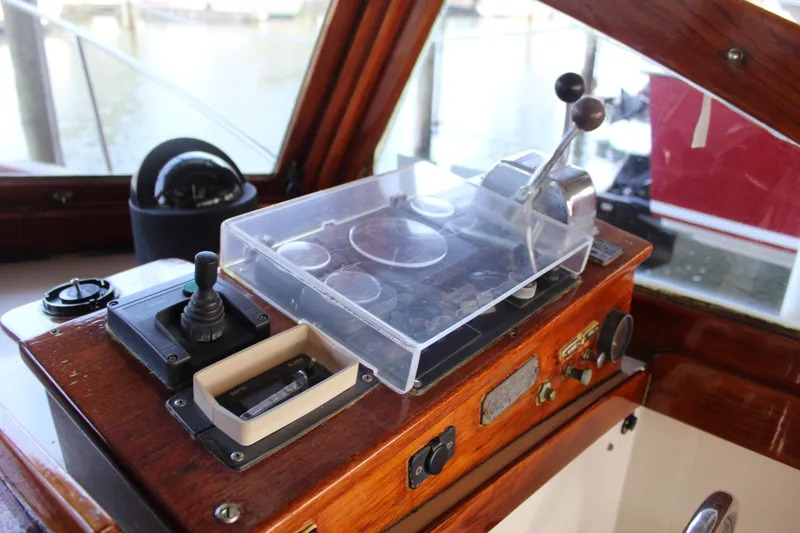 Slide: The Image of 1989 Dyer Downeast boat control panel with throttle and navigation instruments. - 21