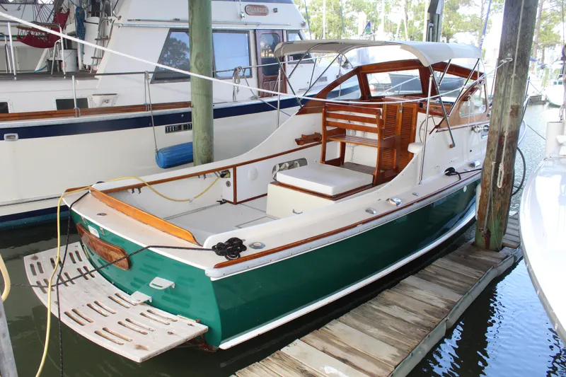 The Image of 1989 Dyer Downeast boat docked, green hull, white deck, wooden accents. - 0