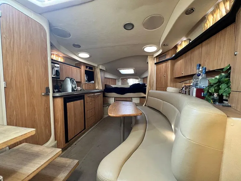 Slide: The Image of Interior of 2006 Sea Ray 340 Sundancer yacht with kitchen, seating, and sleeping area. - 14