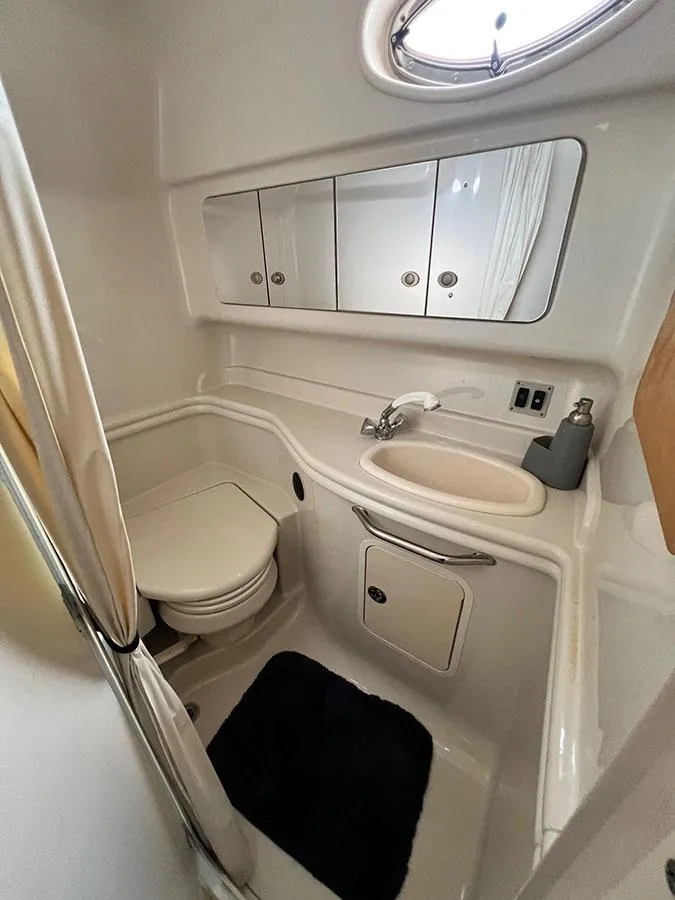 Slide: The Image of 2006 Sea Ray 340 Sundancer bathroom with sink, toilet, and storage cabinets. - 18