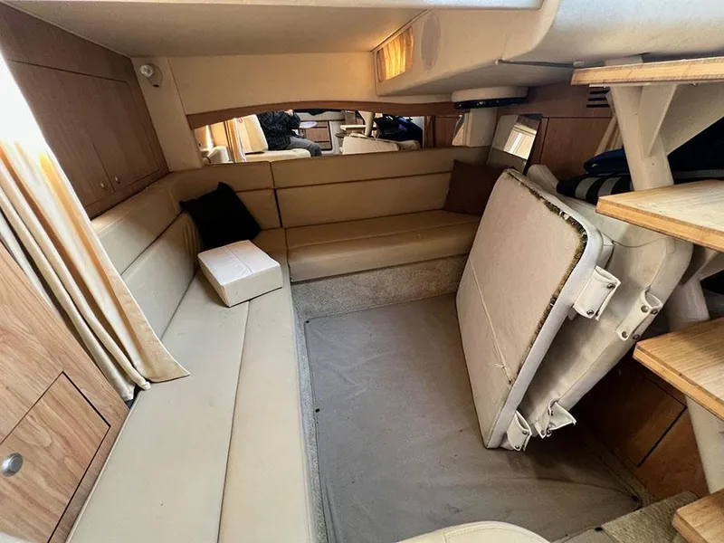 Slide: The Image of Interior of 2006 Sea Ray 340 Sundancer yacht with beige seating and wooden accents. - 19