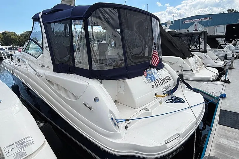 Slide: The Image of 2006 Sea Ray 340 Sundancer docked at marina with American flag. - 2