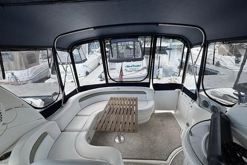 Slide: The Image of Interior view of 2006 Sea Ray 340 Sundancer yacht with seating and wooden table. - 3