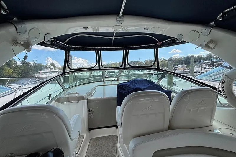 Slide: The Image of Interior view of 2006 Sea Ray 340 Sundancer yacht with white seating and blue canopy. - 4
