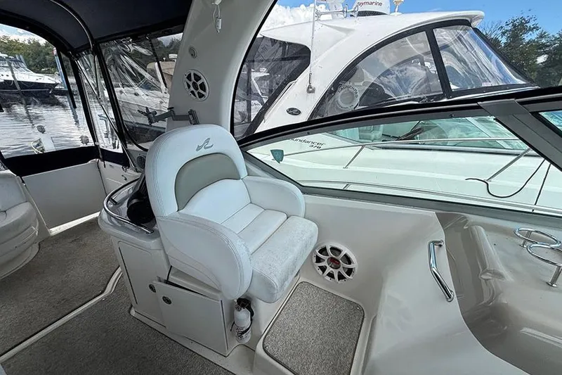 Slide: The Image of 2006 Sea Ray 340 Sundancer cockpit with white seating and marina view. - 7