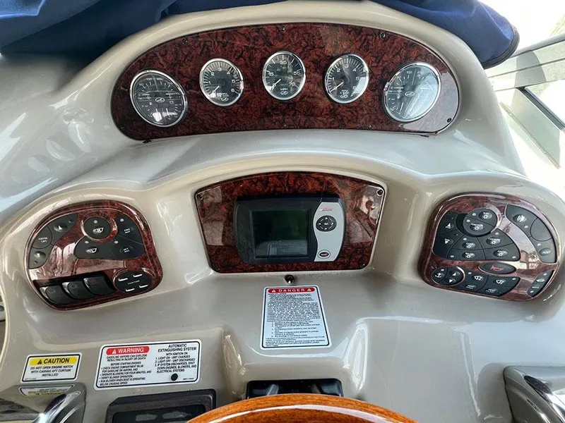 Slide: The Image of Dashboard of a 2006 Sea Ray 340 Sundancer boat with gauges and controls. - 8