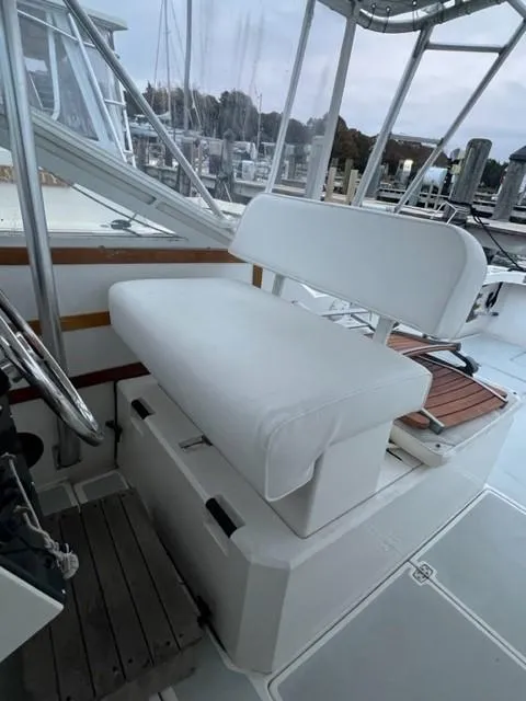 Slide: The Image of 1987 Black Watch 30 EXPRESS boat interior with white cushioned seating. - 4