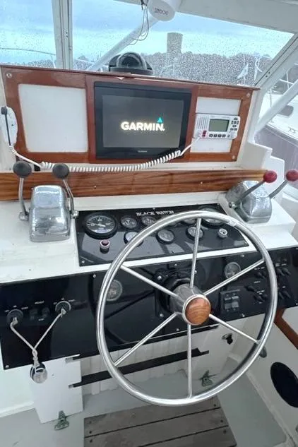 Slide: The Image of 1987 Black Watch 30 EXPRESS helm with Garmin navigation system and classic steering wheel. - 5