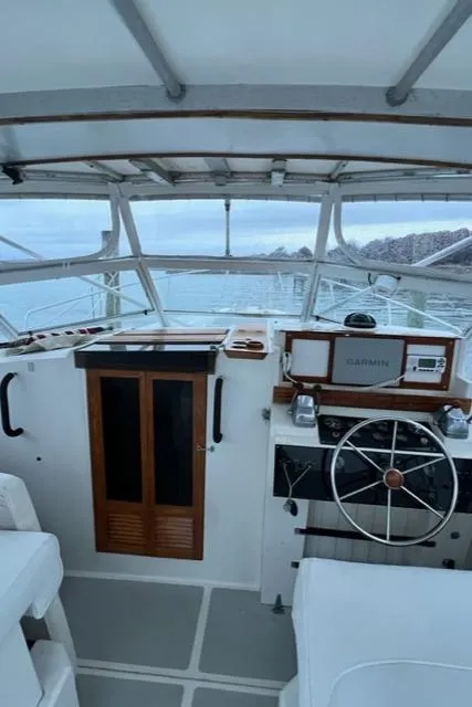 Slide: The Image of Interior view of 1987 Black Watch 30 EXPRESS boat cockpit with steering wheel and controls. - 6