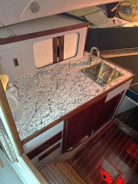 Slide: The Image of 1987 Black Watch 30 EXPRESS boat interior with granite countertop and sink. - 7