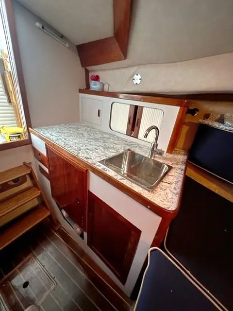 Slide: The Image of 1987 Black Watch 30 EXPRESS boat interior with kitchenette and sink. - 8