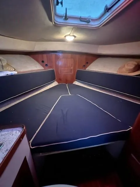 Slide: The Image of Interior cabin of 1987 Black Watch 30 EXPRESS boat with blue cushions. - 9